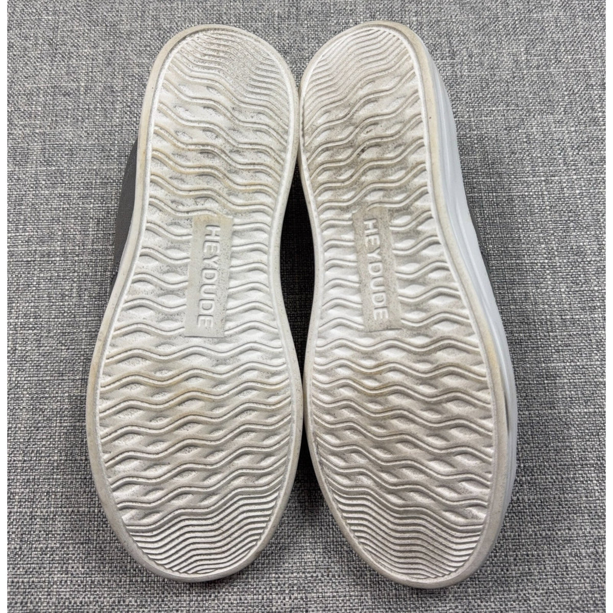 Second Half Supply Co, LLC Hey Dude Karina sneakers showing the white wavy tread outsoles with brand logo