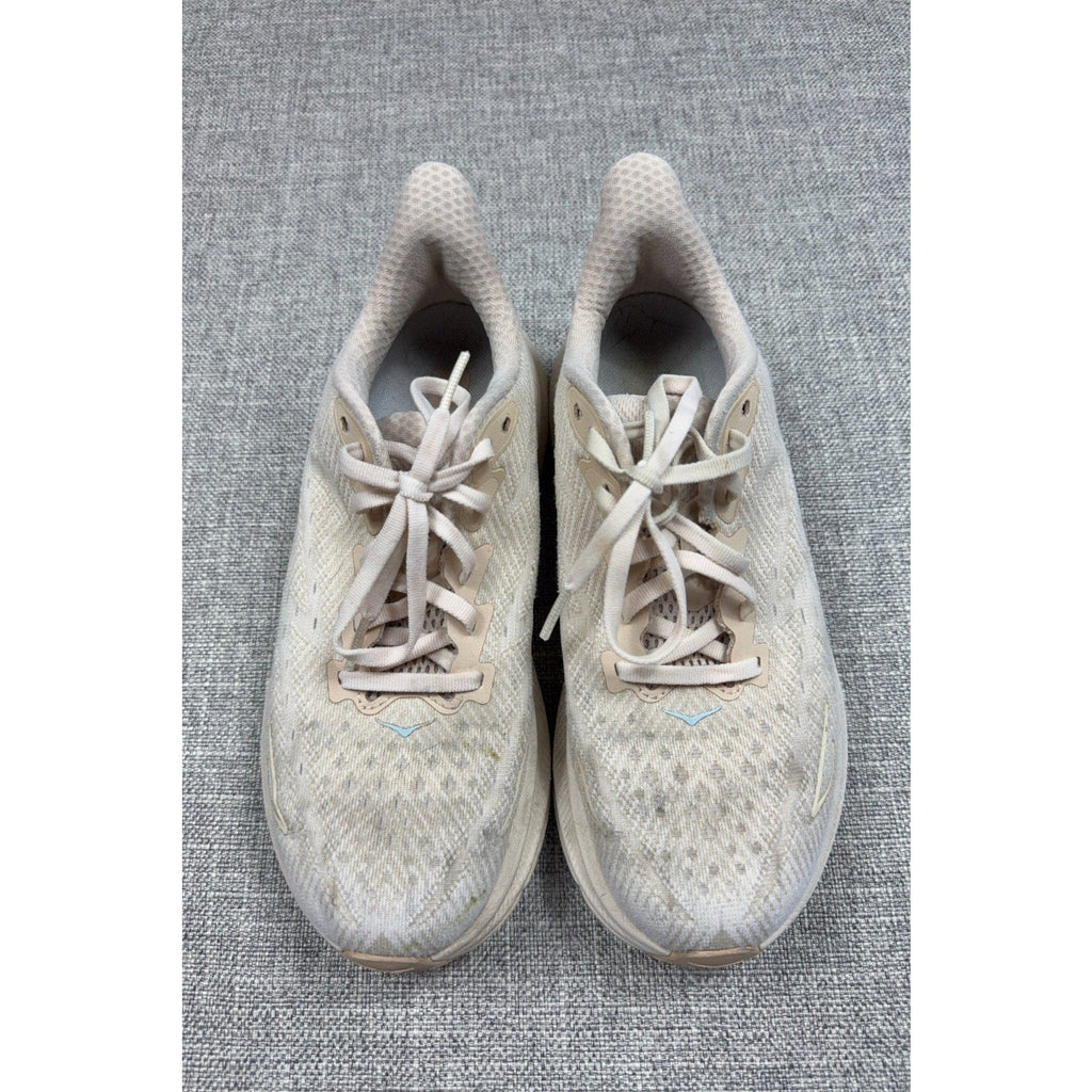 Second Half Supply Co, LLC HOKA Clifton 9 women's running shoes in shifting sand and eggnog with lace-up textile uppers.