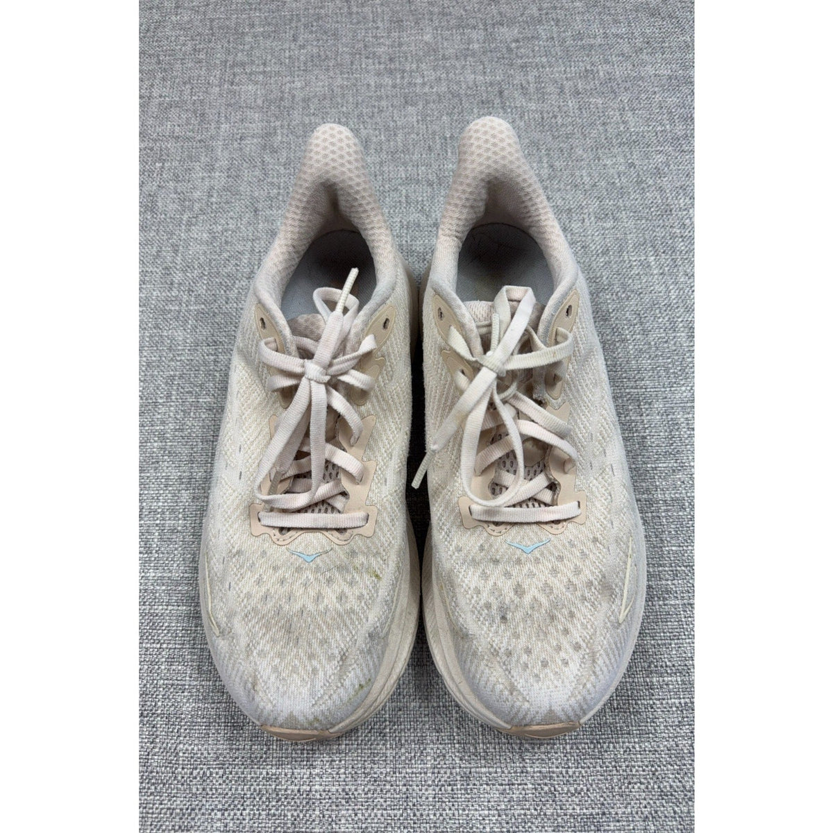Second Half Supply Co, LLC HOKA Clifton 9 women's running shoes in shifting sand and eggnog with lace-up textile uppers.