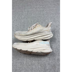 Second Half Supply Co, LLC HOKA Clifton 9 women's running shoes in shifting sand and eggnog with cushioned midsoles.