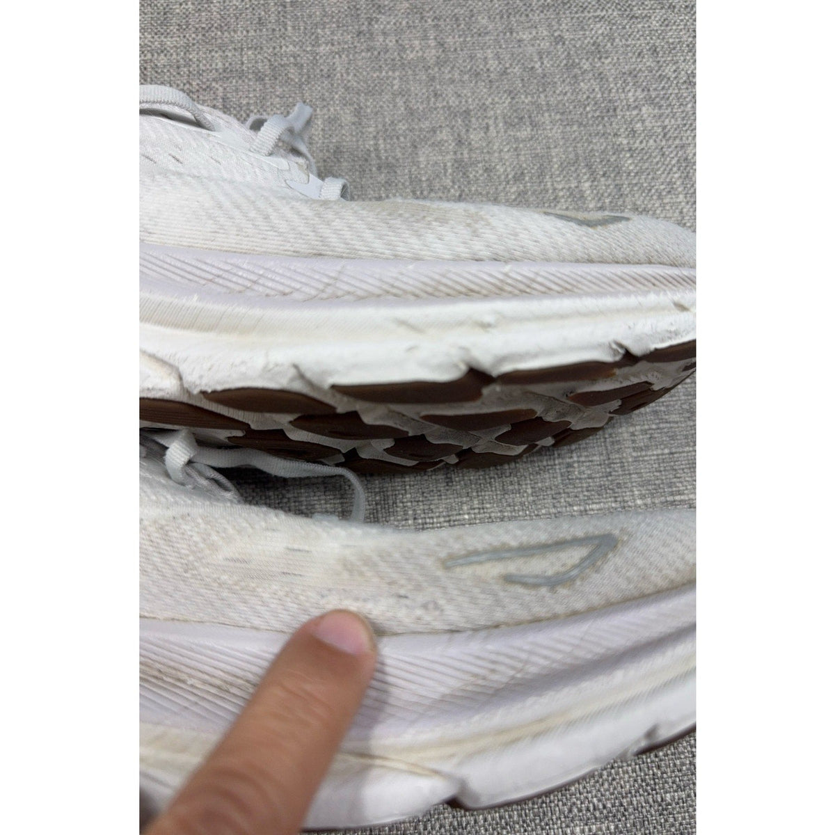 Second Half Supply Co, LLC pre-owned white HOKA Clifton 9 running shoes showing midsole wear and cosmetic scuffs