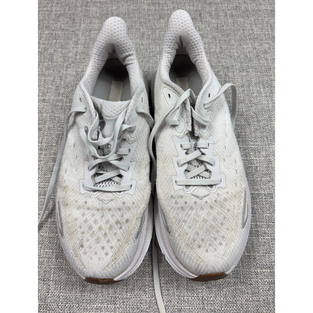 Second Half Supply Co, LLC pre-owned white HOKA Clifton 9 women's running shoes with knit uppers and cushioned midsoles.