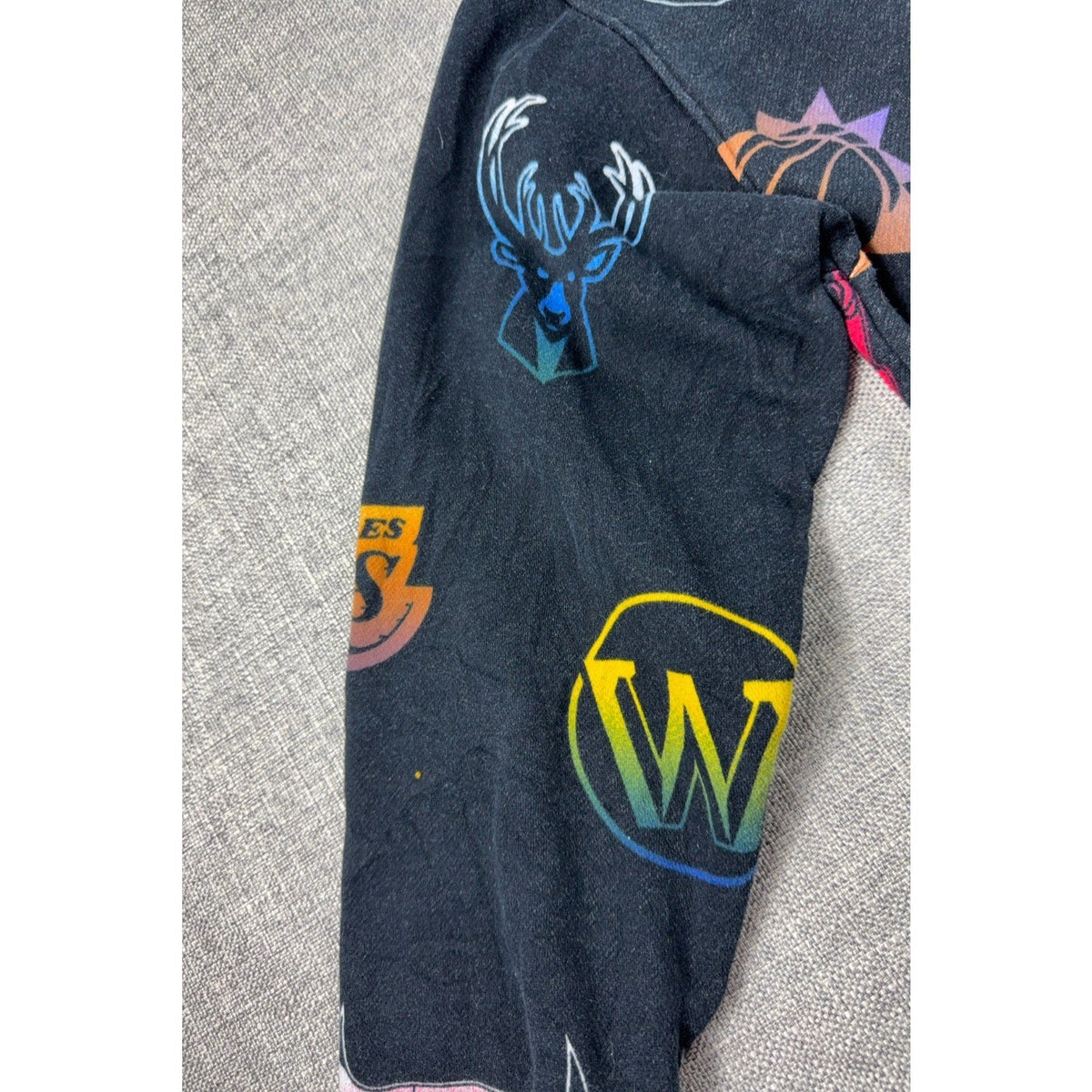 Second Half Supply Co, LLC Hollister NBA charcoal fleece hoodie sleeve with multicolor team logo print