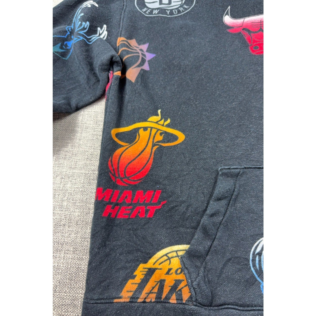 Second Half Supply Co, LLC Hollister NBA charcoal hoodie with allover multicolor team logos and kangaroo pocket