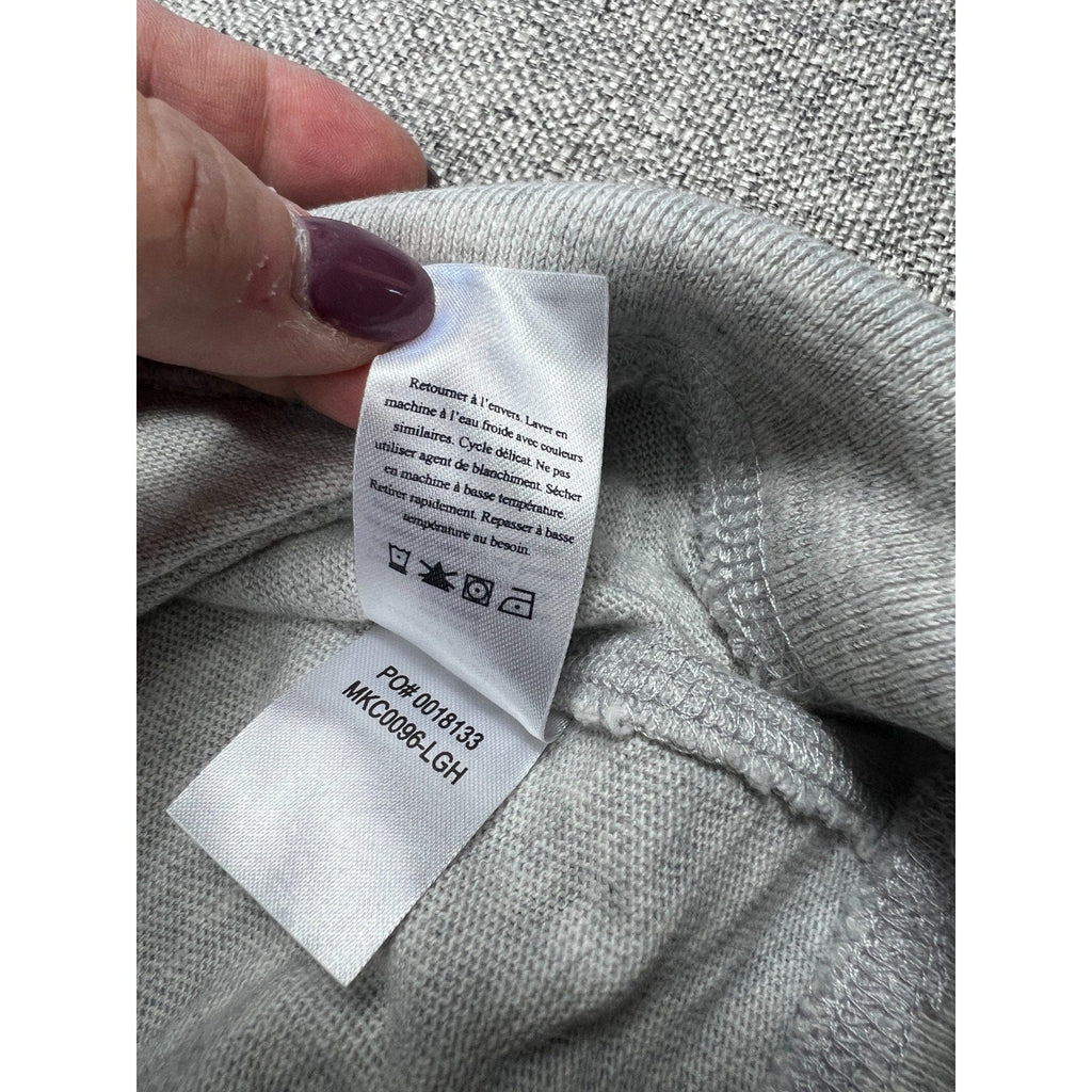 Second Half Supply Co, LLC care and style tag on a light gray Faherty organic cotton hoodie with washing instructions.