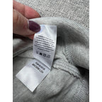 Second Half Supply Co, LLC care and style tag on a light gray Faherty organic cotton hoodie with washing instructions.