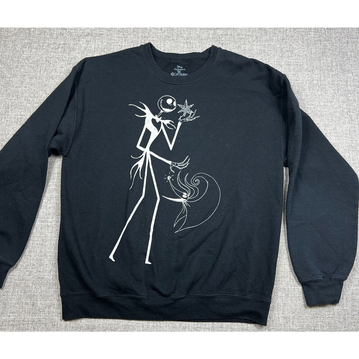 Second Half Supply Co, LLC black crewneck sweatshirt featuring a white line-art graphic of Jack Skellington and Zero.