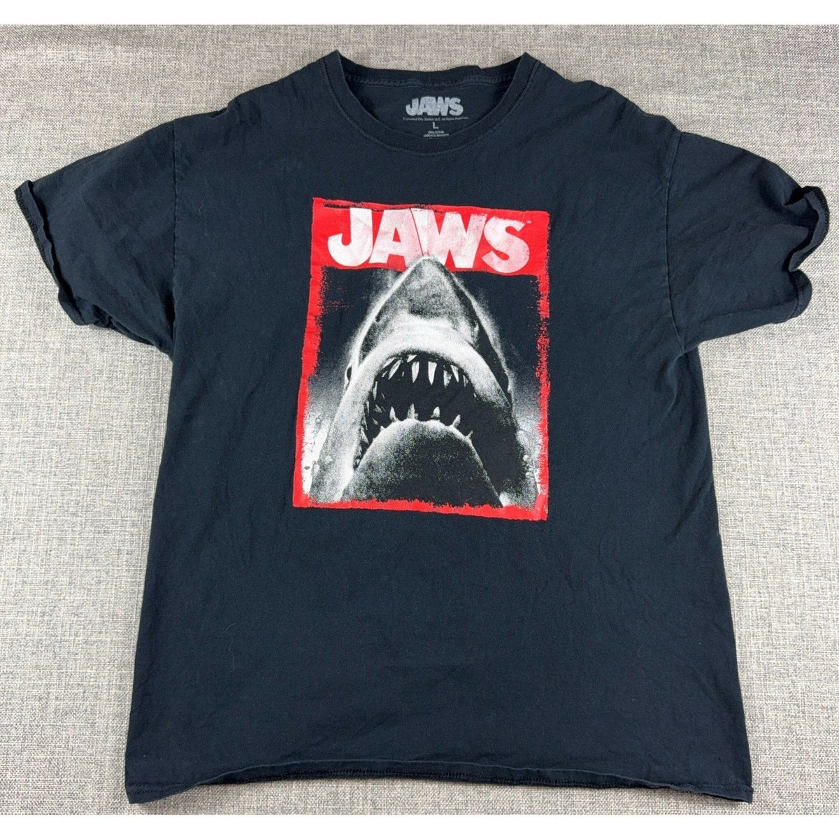 Second Half Supply Co, LLC black Jaws movie graphic t-shirt with a great white shark print in red and white