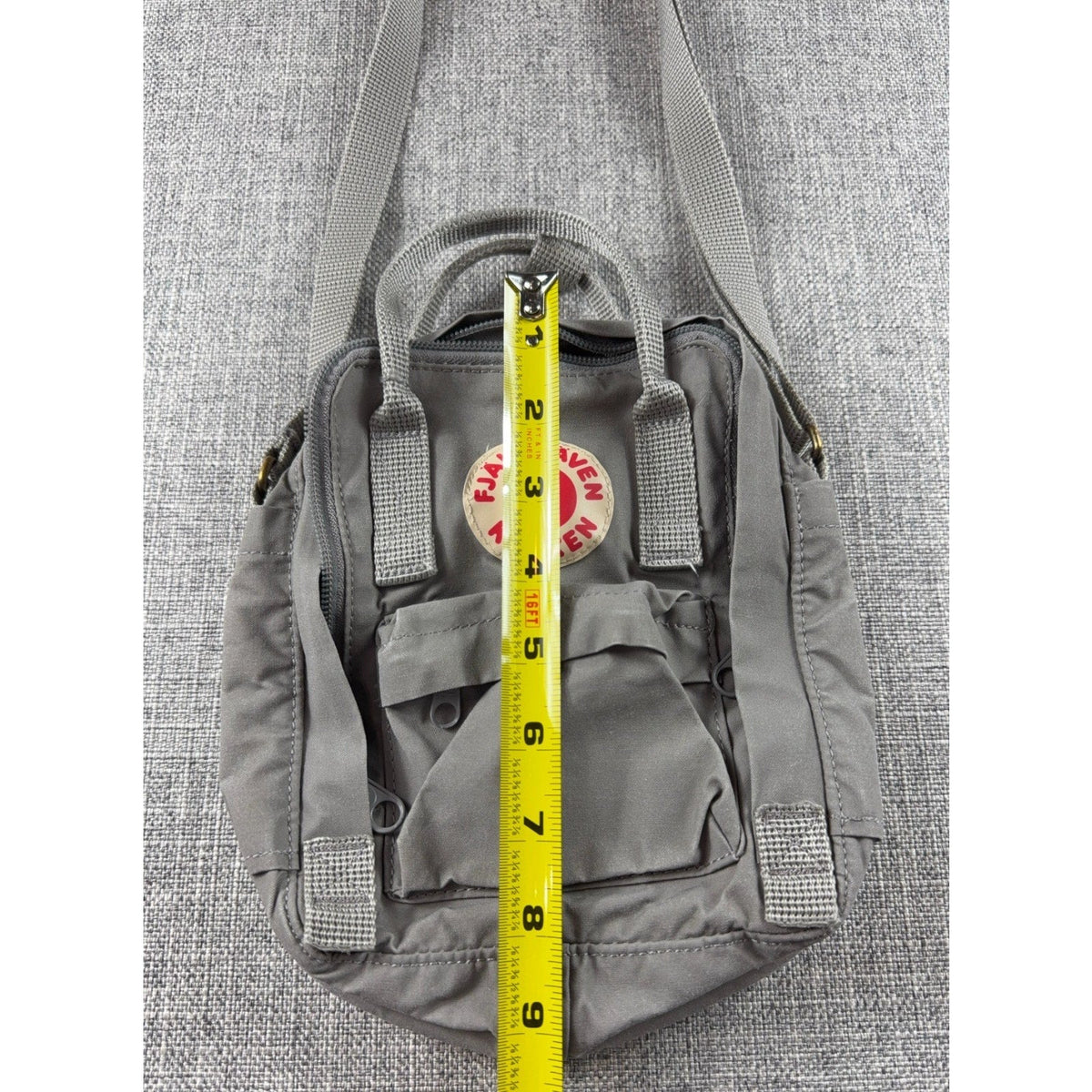 Second Half Supply Co, LLC Fjallraven Kanken Sling bag in Fog gray with a measuring tape showing 9 inch height