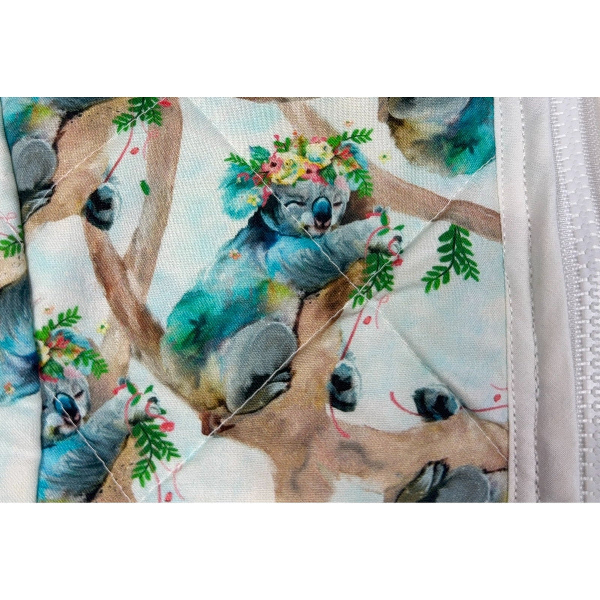 Second Half Supply Co, LLC handmade quilted vest featuring a watercolor koala and floral print with diamond stitching.