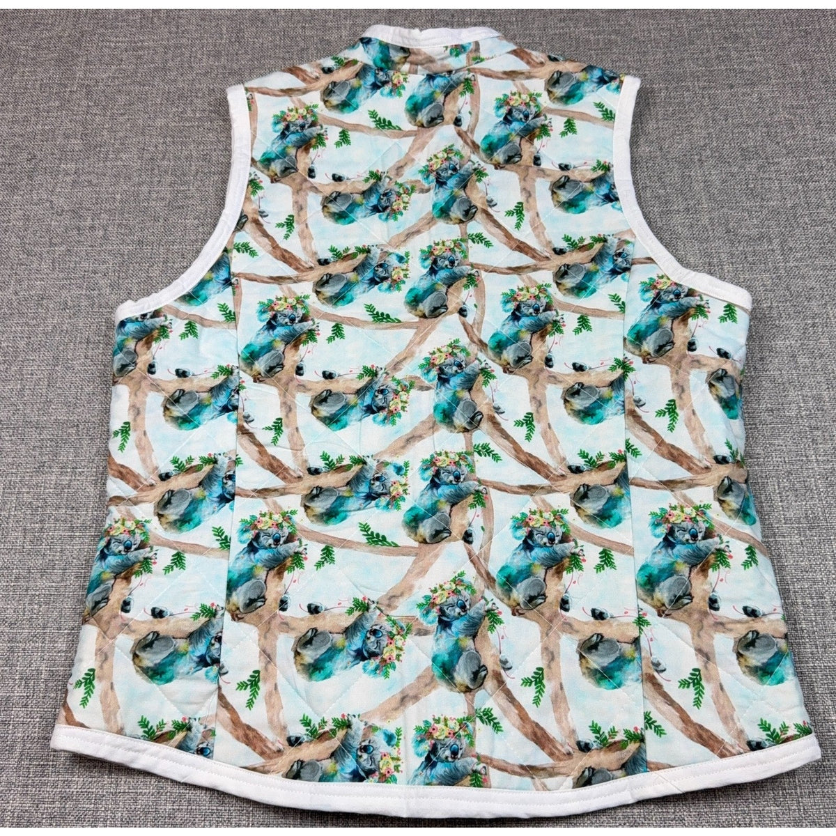 Second Half Supply Co, LLC handmade quilted vest featuring a watercolor koala and floral branch print on light blue