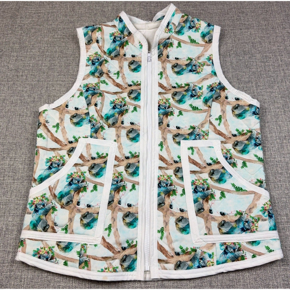Second Half Supply Co, LLC handmade quilted vest with watercolor koala and floral print, zip front, and patch pockets.