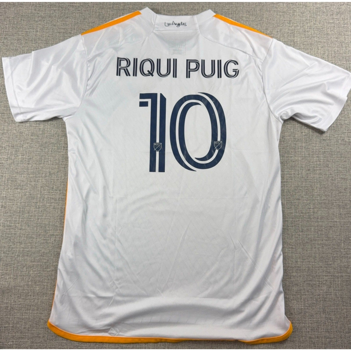 Back view of Second Half Supply Co, LLC white Adidas LA Galaxy 2024-25 soccer jersey with Riqui Puig number 10