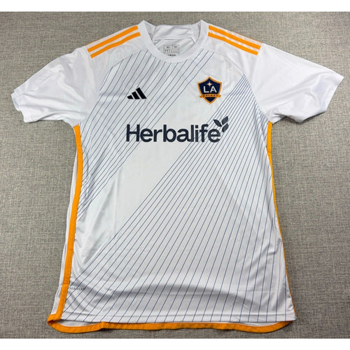 Second Half Supply Co, LLC Adidas LA Galaxy 2024-25 white soccer jersey with gold stripes and Herbalife sponsor