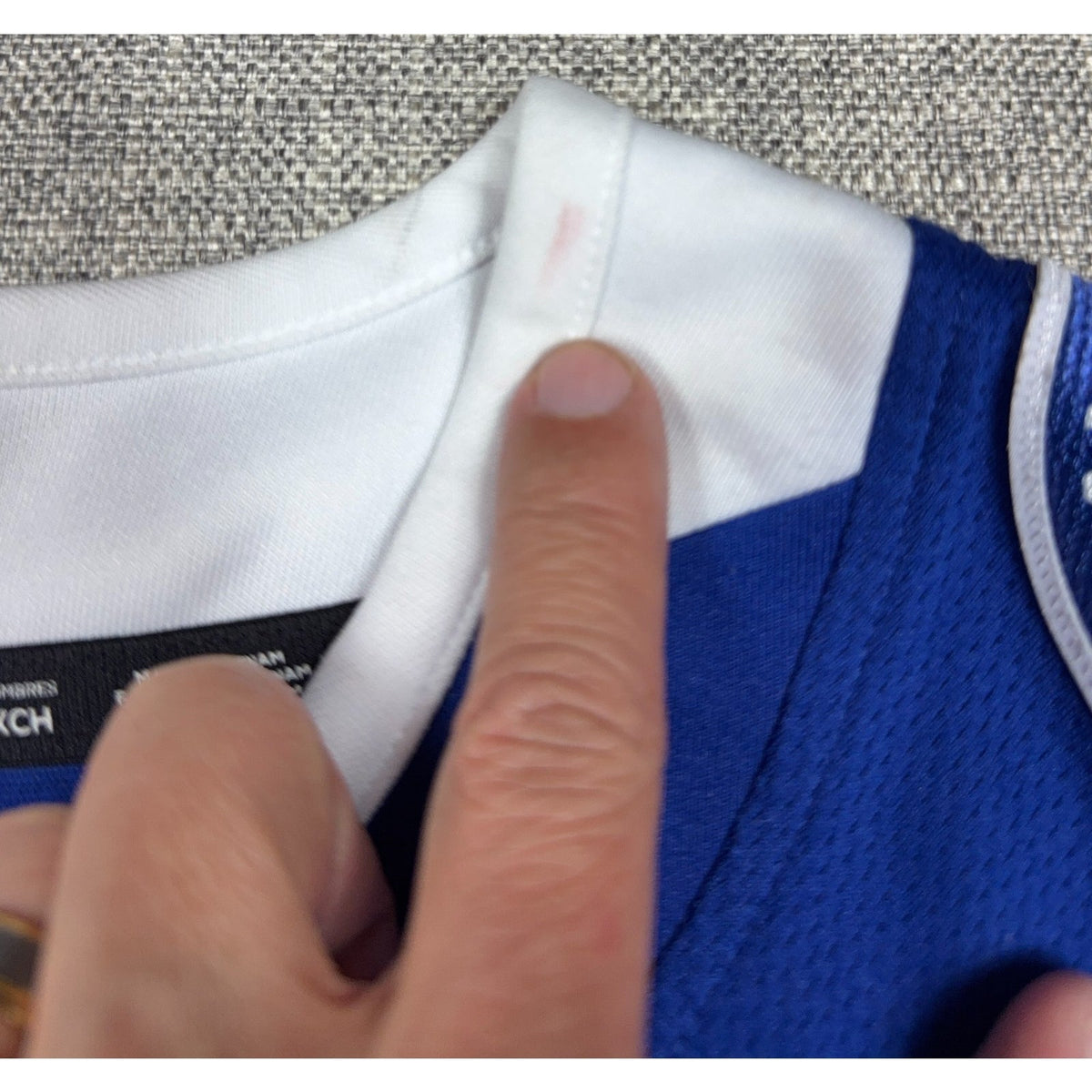 Second Half Supply Co, LLC Tampa Bay Lightning jersey collar showing a small pink stain on the white fabric