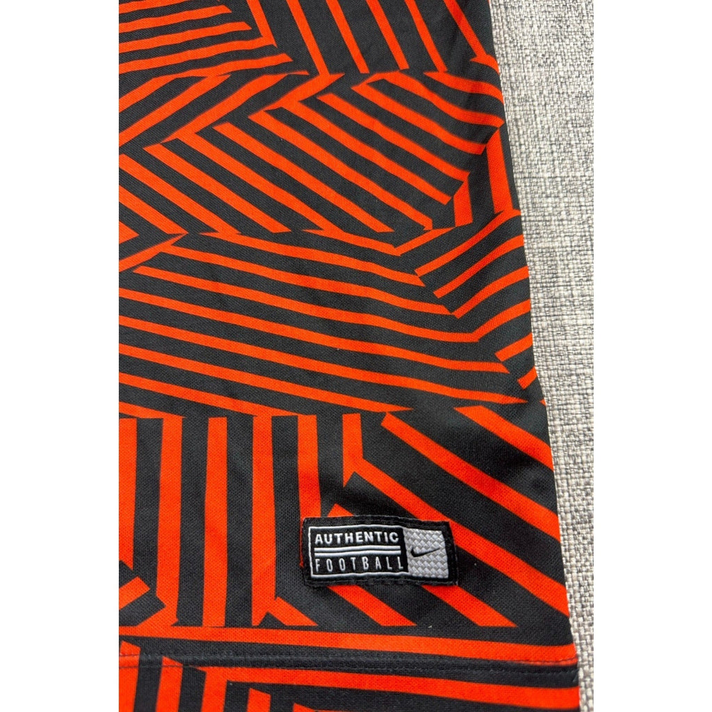 Second Half Supply Co, LLC Manchester City Nike soccer shirt featuring a red and black geometric pattern and hem patch