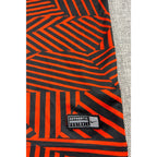 Second Half Supply Co, LLC Manchester City Nike soccer shirt featuring a red and black geometric pattern and hem patch