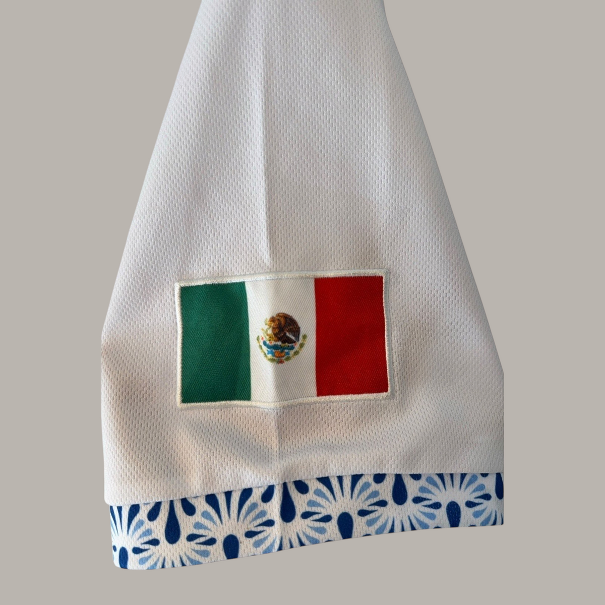 Second Half Supply Co, LLC white mesh baseball jersey sleeve with Mexican flag patch and blue Talavera-style trim