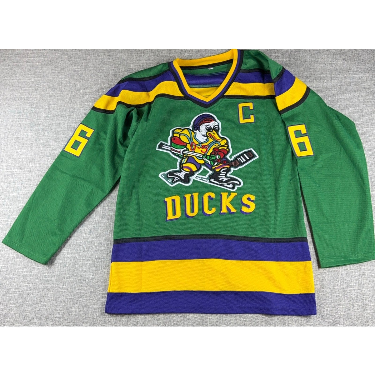 Second Half Supply Co, LLC green Mighty Ducks Charlie Conway #96 hockey jersey with embroidered duck logo and captain C
