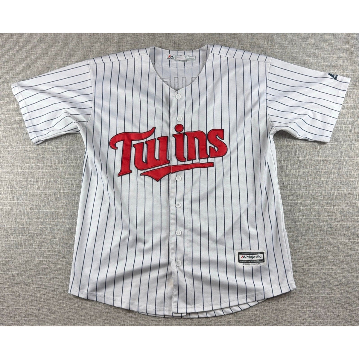 Second Half Supply Co, LLC white Minnesota Twins pinstripe baseball jersey with red Twins script and button front.