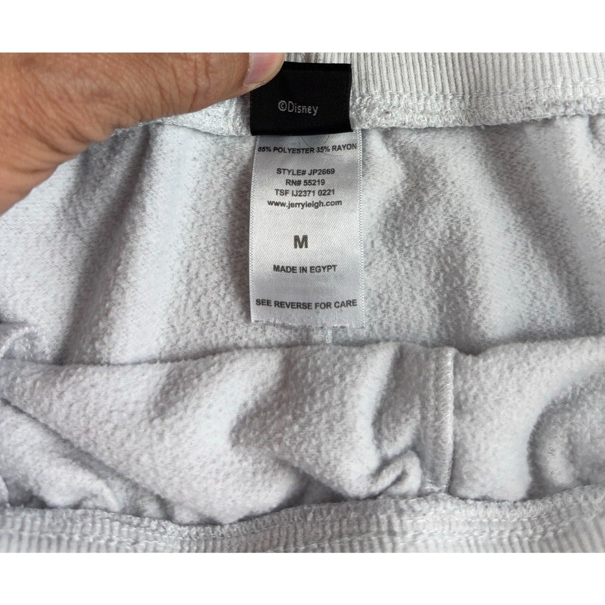 Second Half Supply Co, LLC Minnie Mouse jogger pants interior care label showing material and size medium details