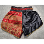 Second Half Supply Co, LLC Thai Battle Boxing Muay Thai shorts in black satin and red gold brocade with side slits.