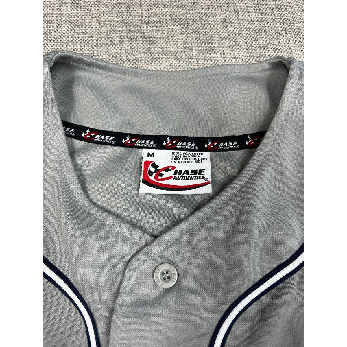 Second Half Supply Co, LLC vintage Chase Authentics NASCAR jersey collar and size tag detail in gray polyester.
