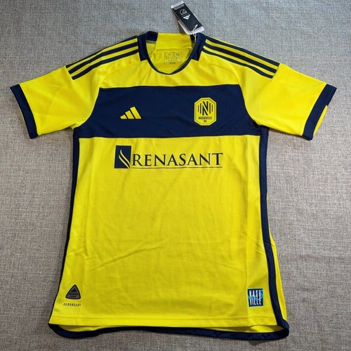 Second Half Supply Co, LLC Adidas Nashville SC 2024/25 authentic home soccer jersey in yellow and navy blue