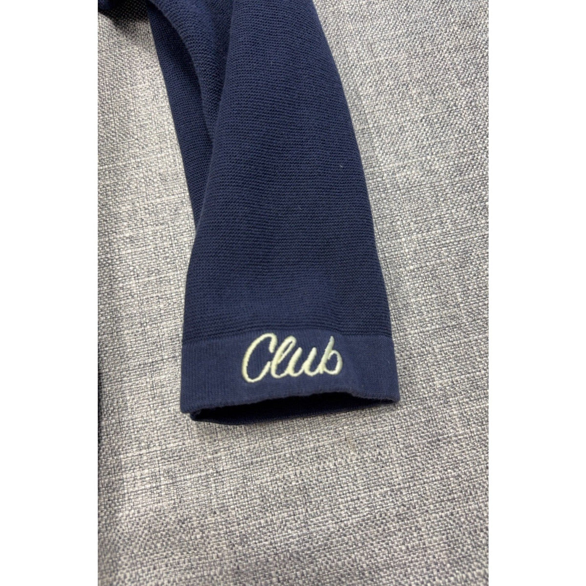 Second Half Supply Co, LLC navy knit cardigan sleeve with white embroidered Club script on the cuff