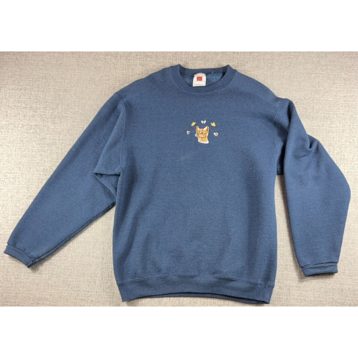Second Half Supply Co, LLC navy blue crewneck sweatshirt featuring an embroidered orange kitten and butterflies.