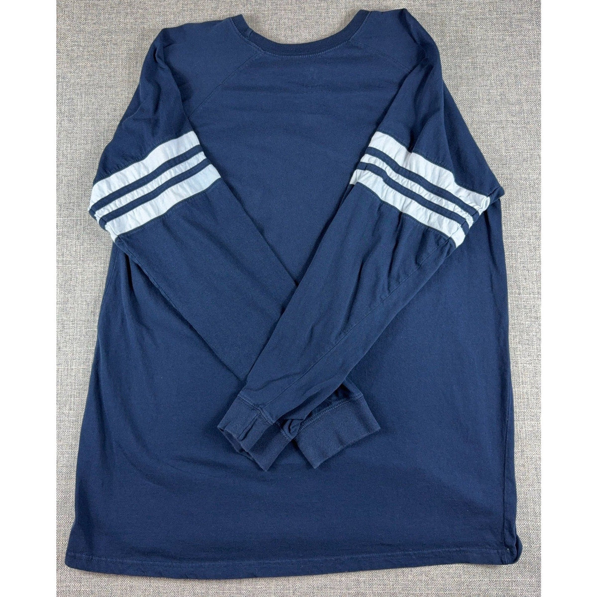 Second Half Supply Co, LLC navy blue long sleeve shirt with white varsity stripes on sleeves, back view