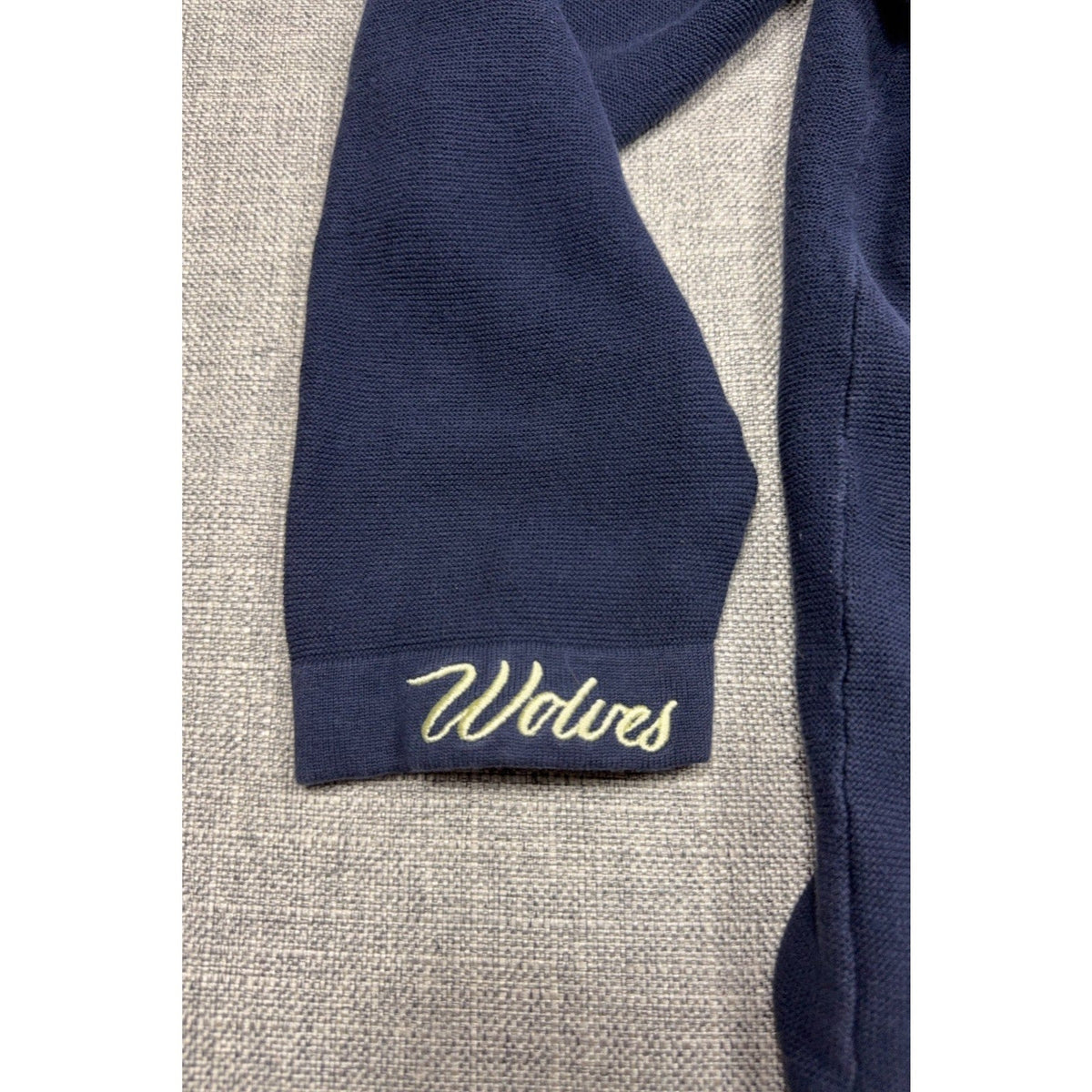 Second Half Supply Co, LLC navy knit cardigan sleeve with cream Wolves embroidery on the cuff