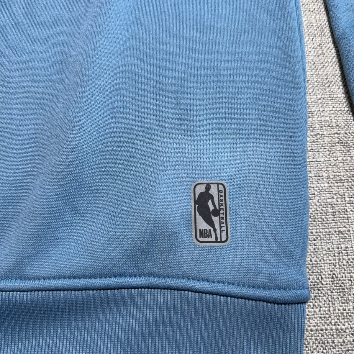 Second Half Supply Co, LLC blue fleece sweatshirt with NBA logo patch near the ribbed hem