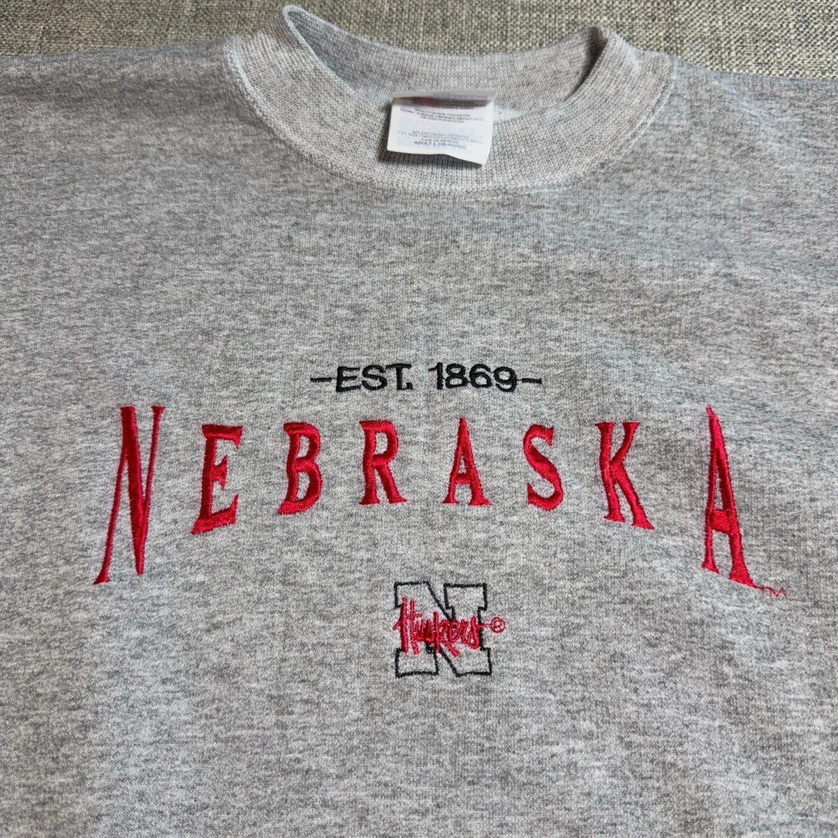 Second Half Supply Co, LLC vintage gray Nebraska Cornhuskers crewneck sweatshirt with red and black embroidery.