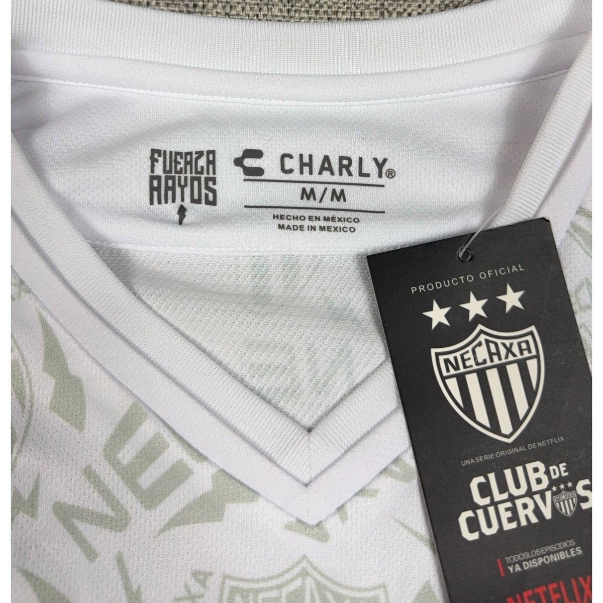 Second Half Supply Co, LLC Charly Necaxa 2019/20 jersey collar with Club de Cuervos Netflix promotional hangtag