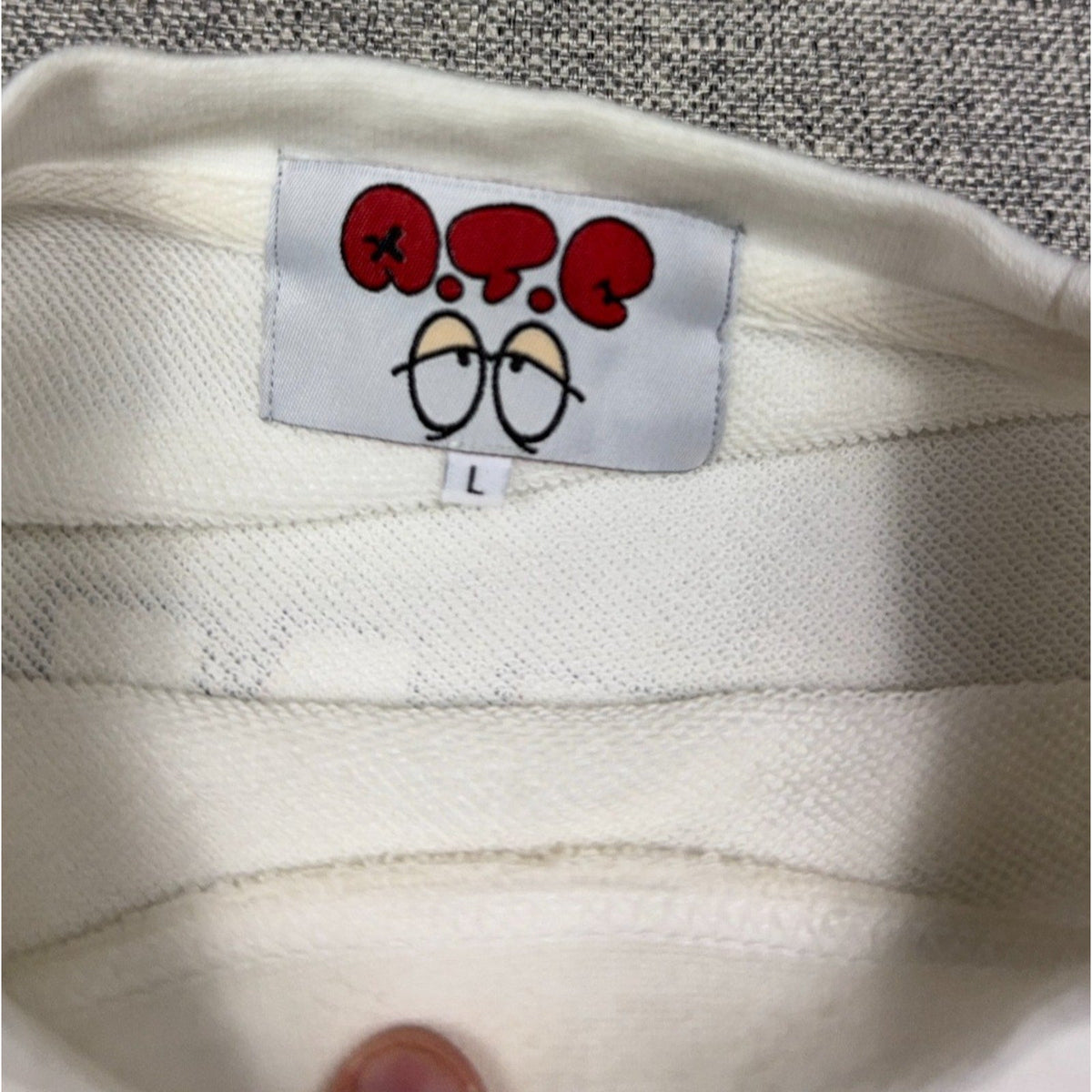 Second Half Supply Co, LLC white New Jack ATC sweatshirt interior neck label with cartoon eyes graphic and size L tag