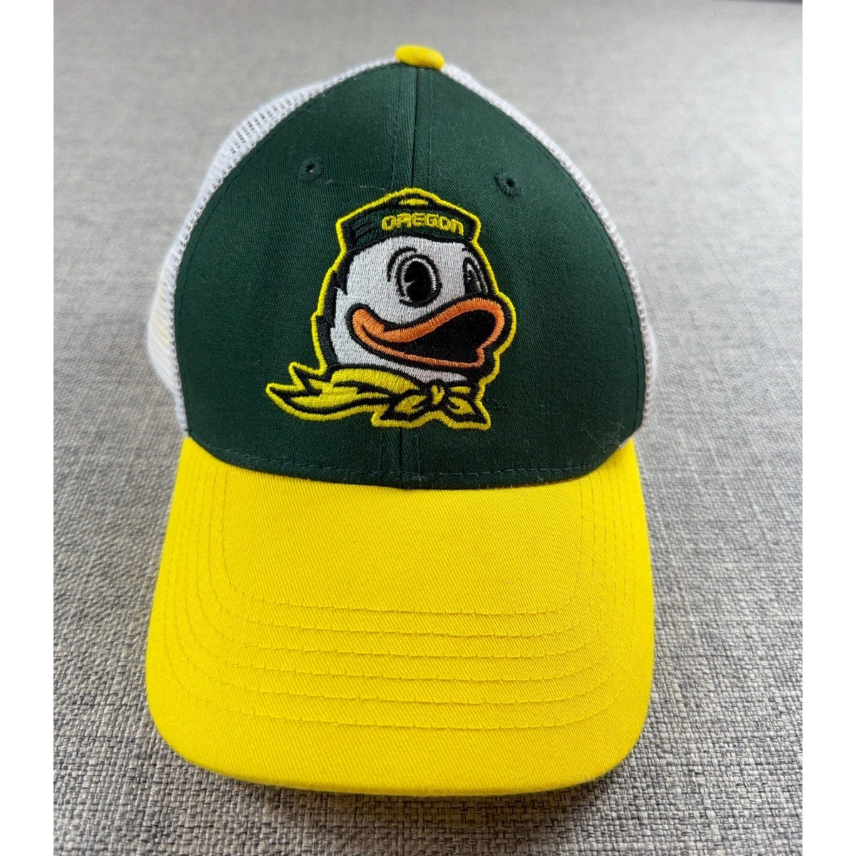 Second Half Supply Co, LLC Oregon Ducks trucker hat with green front, yellow bill, and embroidered mascot logo