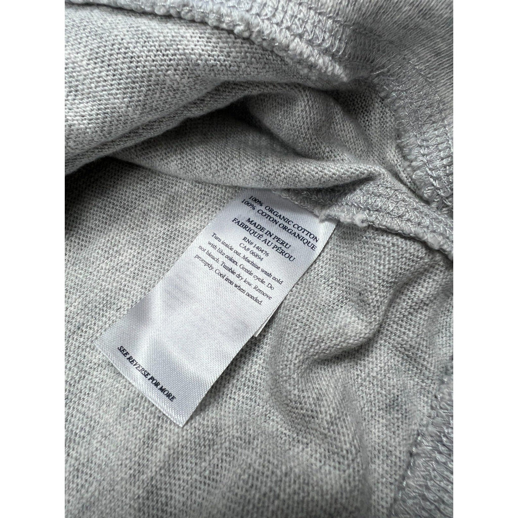 Second Half Supply Co, LLC organic cotton care tag on a light heather gray Faherty hoodie fabric