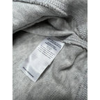 Second Half Supply Co, LLC organic cotton care tag on a light heather gray Faherty hoodie fabric