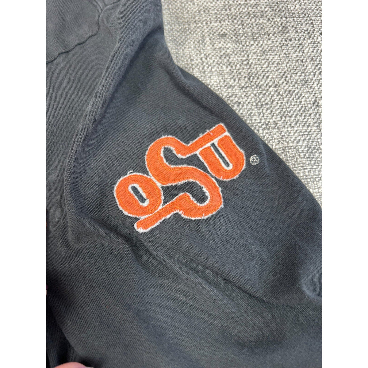 Second Half Supply Co, LLC black long sleeve shirt featuring an embroidered orange OSU logo on the sleeve