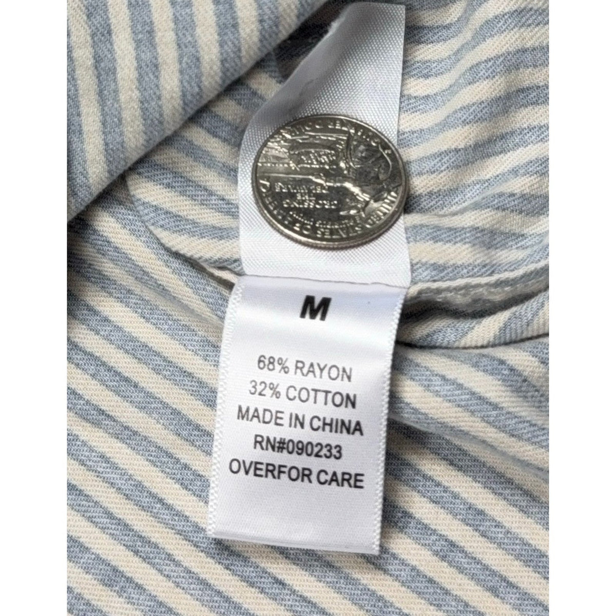Second Half Supply Co, LLC PacSun shirt fabric care tag showing rayon cotton blend and size medium