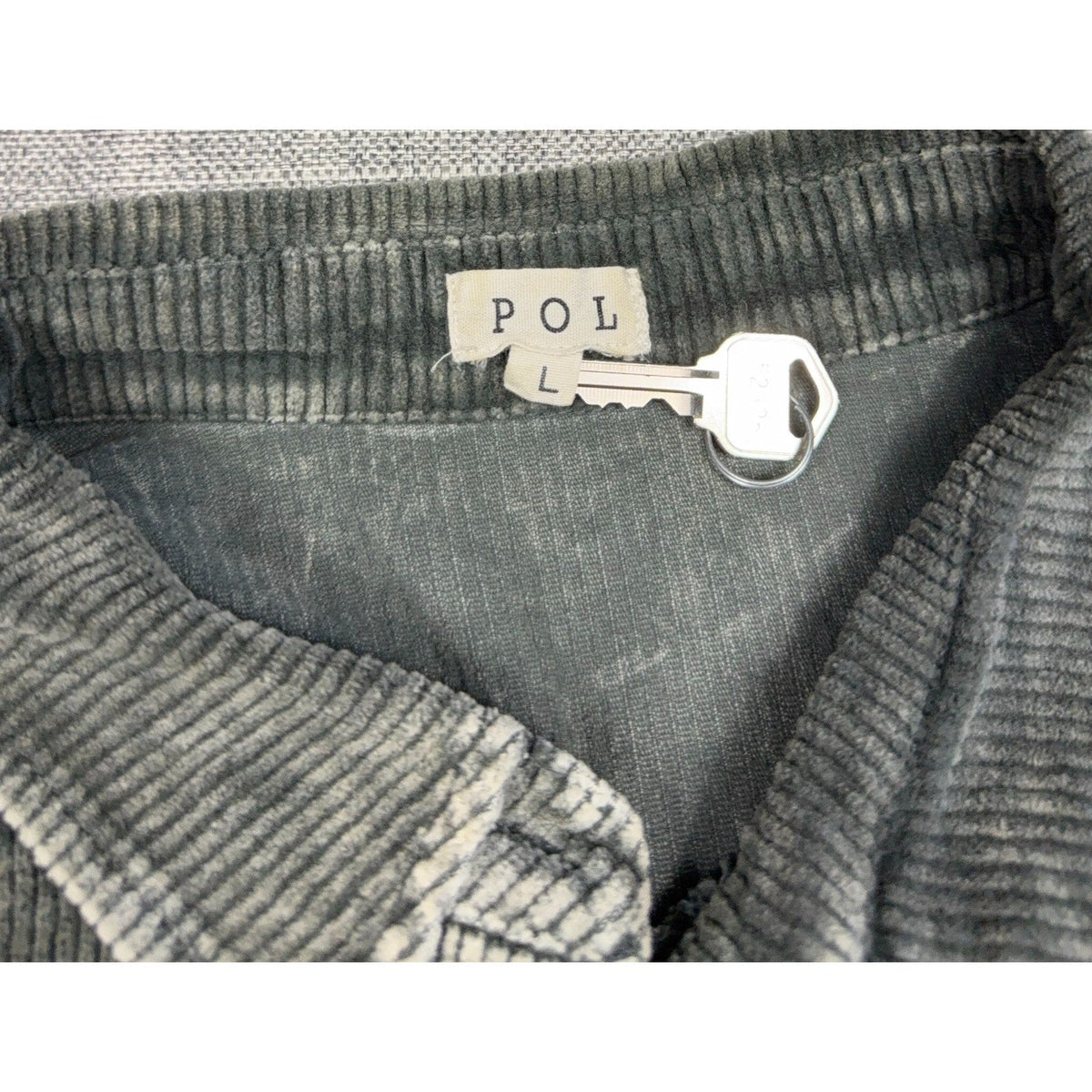 Second Half Supply Co, LLC POL brand label on a gray-green corduroy shacket with size large tag and metal key