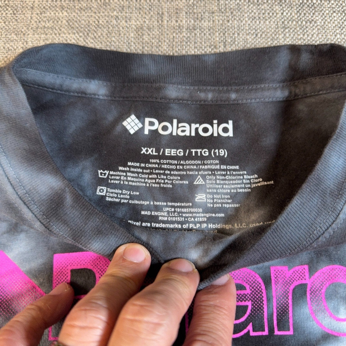 Second Half Supply Co, LLC Polaroid shirt interior neck label showing size XXL and 100% cotton material details