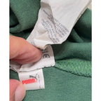 Second Half Supply Co, LLC Puma rugby shirt interior care label and branding on green cotton fabric
