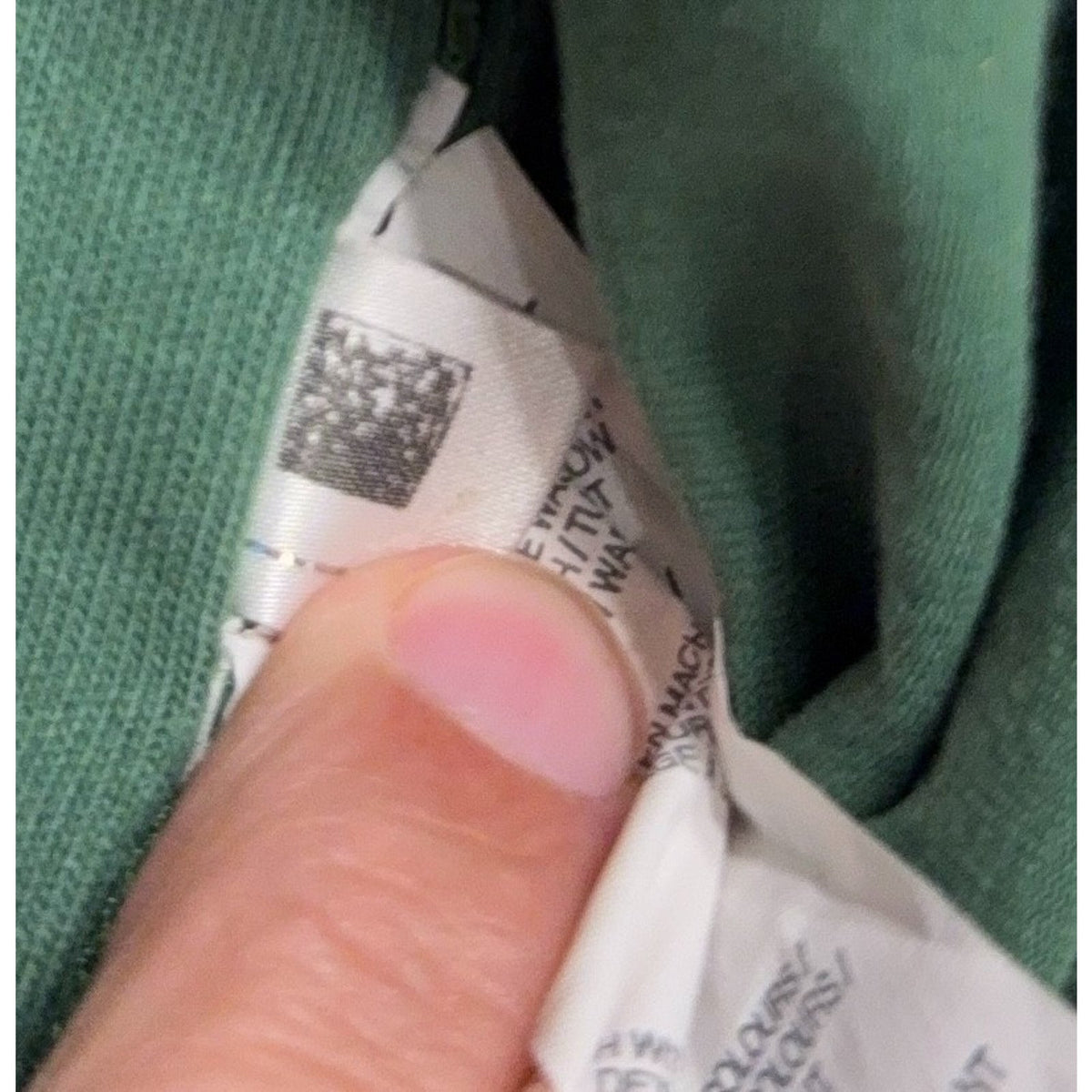 Second Half Supply Co, LLC Puma rugby shirt care label showing fabric and washing instructions on green cotton fabric