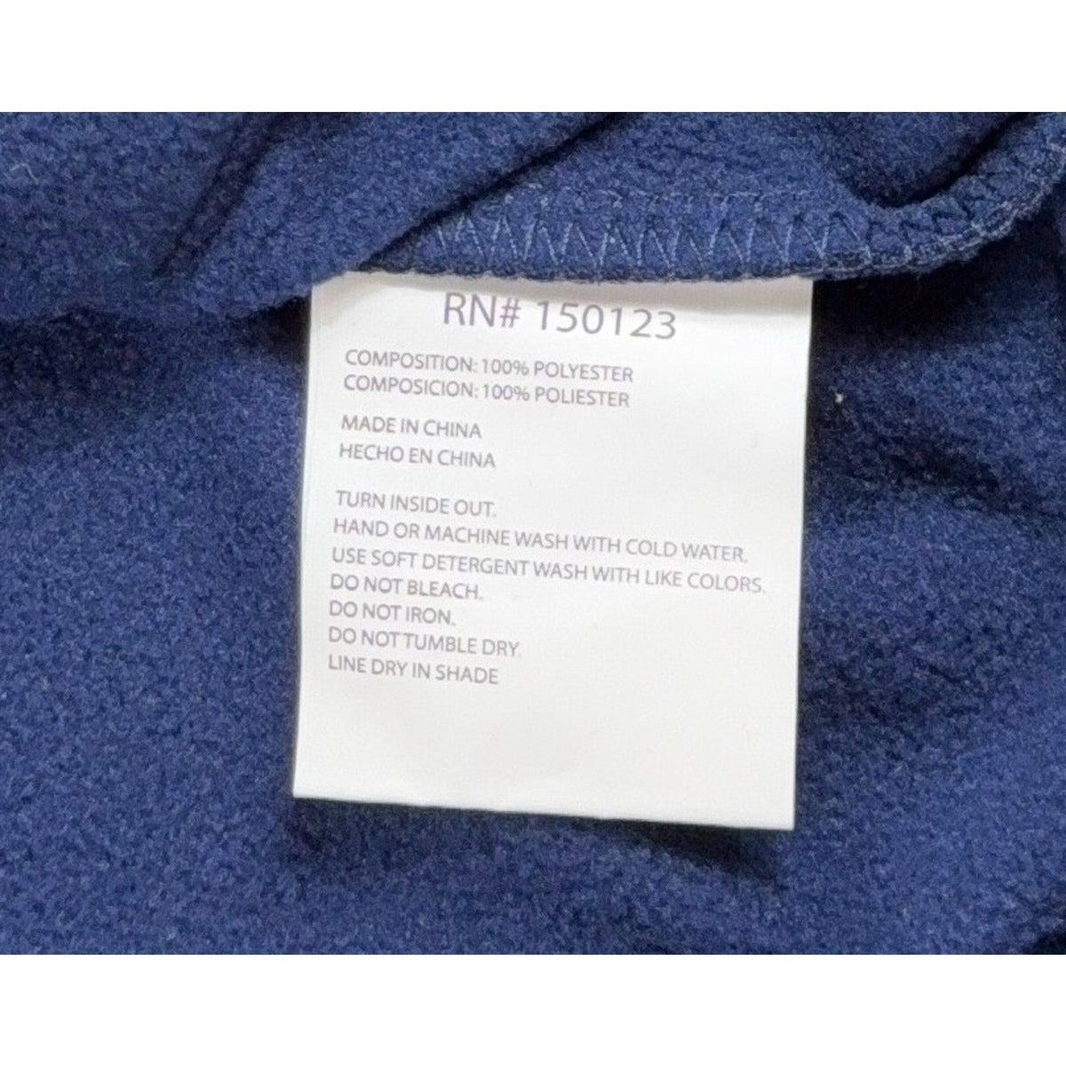 Second Half Supply Co, LLC Pumas UNAM hoodie polyester care label with washing instructions on navy blue fleece fabric