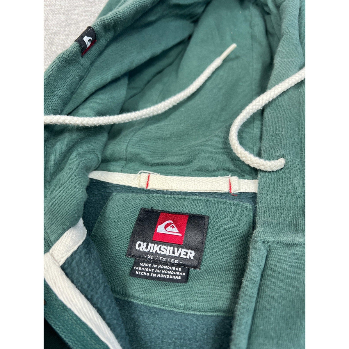 Second Half Supply Co, LLC Quiksilver green fleece hoodie interior with white drawstrings and brand neck label