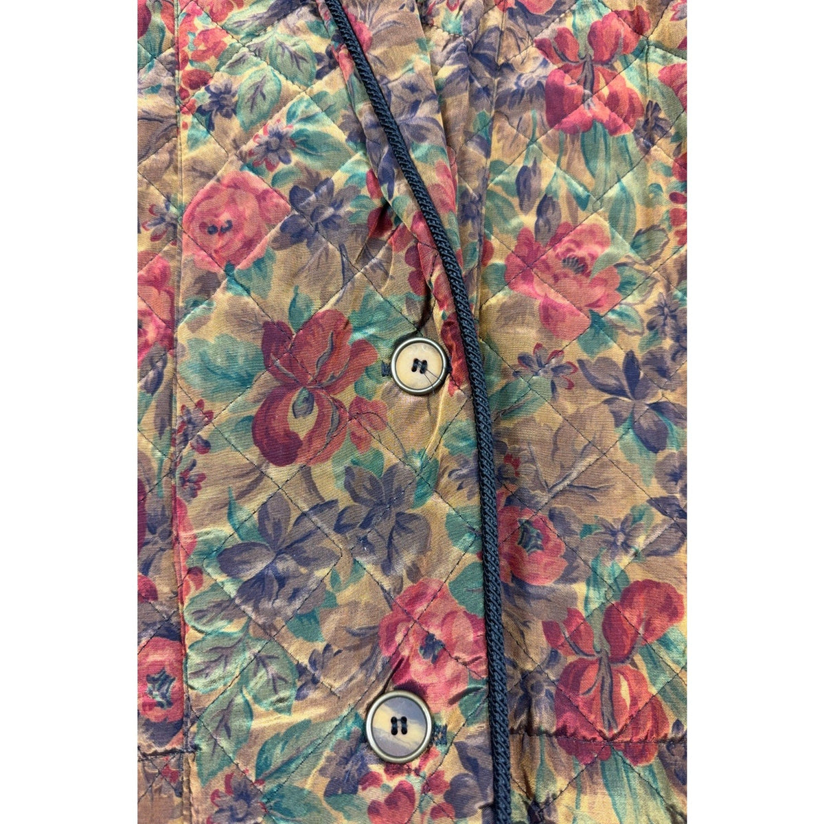 Second Half Supply Co, LLC vintage quilted jacket featuring an autumn floral print with black piping and two buttons.