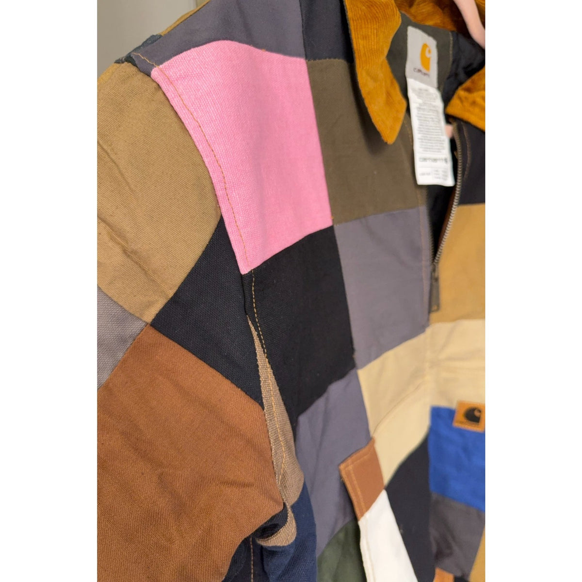 Second Half Supply Co, LLC reworked Carhartt patchwork jacket with pink, blue, and earth-tone panels and corduroy collar