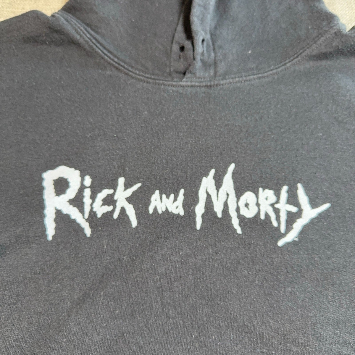 Second Half Supply Co, LLC black Rick and Morty pullover hoodie with white logo graphic on the chest